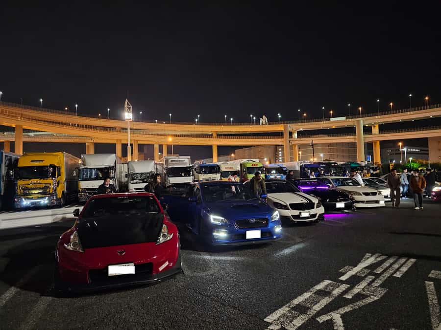 Tokyo: Fast & Furious Authentic Drift and JDM Experience - Daikoku Parking Area car meet stop, where the scene shifts